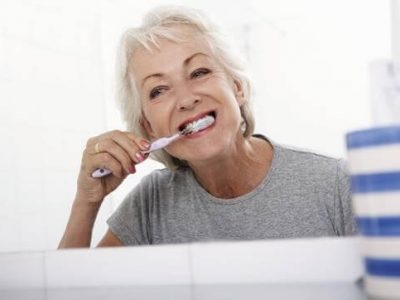 Middle-aged woman brushing her teeth