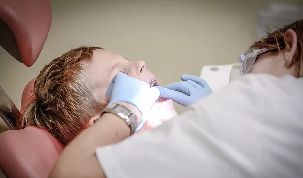Dentist examining child patient